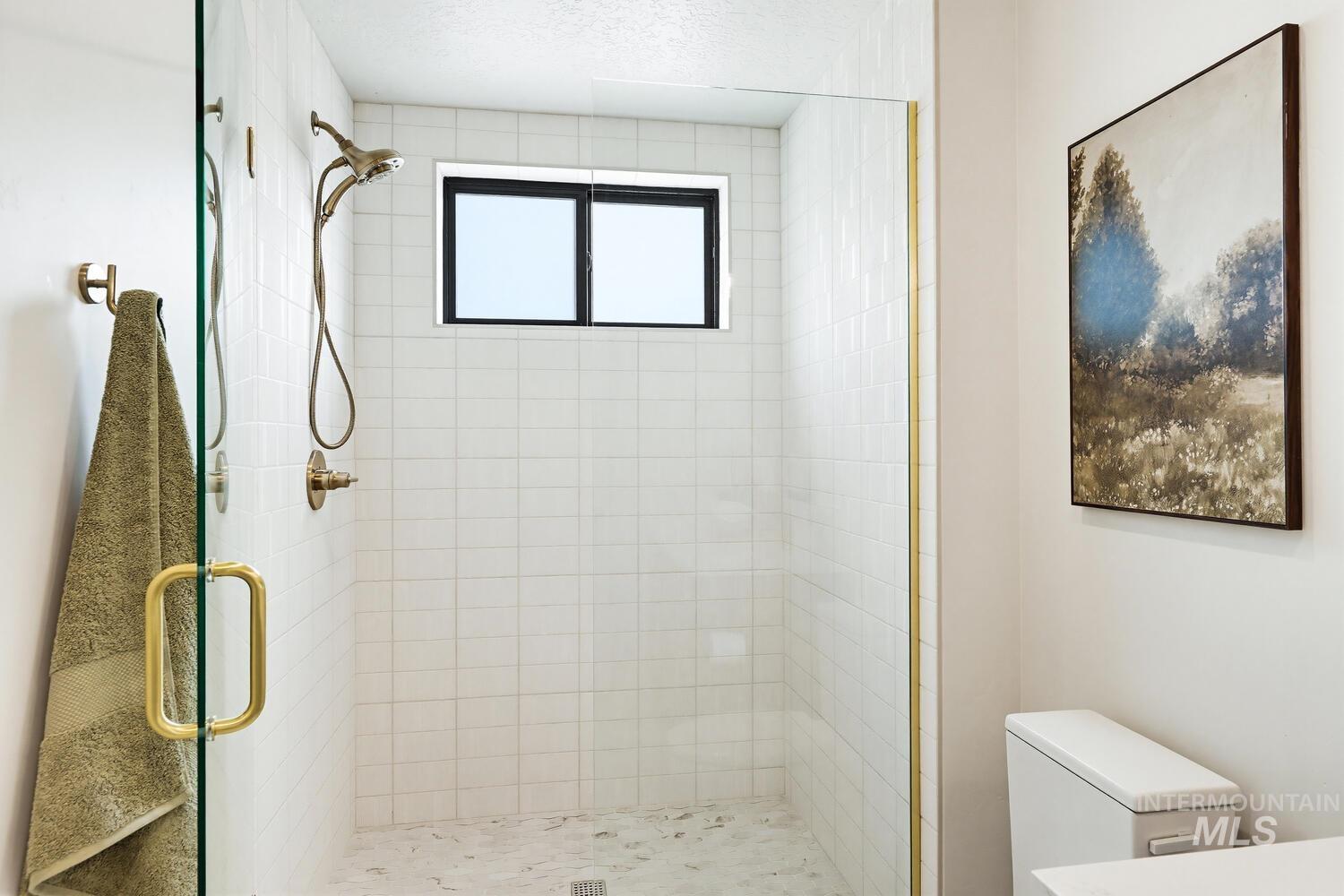 4250 Haystack, Unit 104 Boise, ID 83716 - Photo 17 of 49 Full bathroom featuring a shower stall and toilet