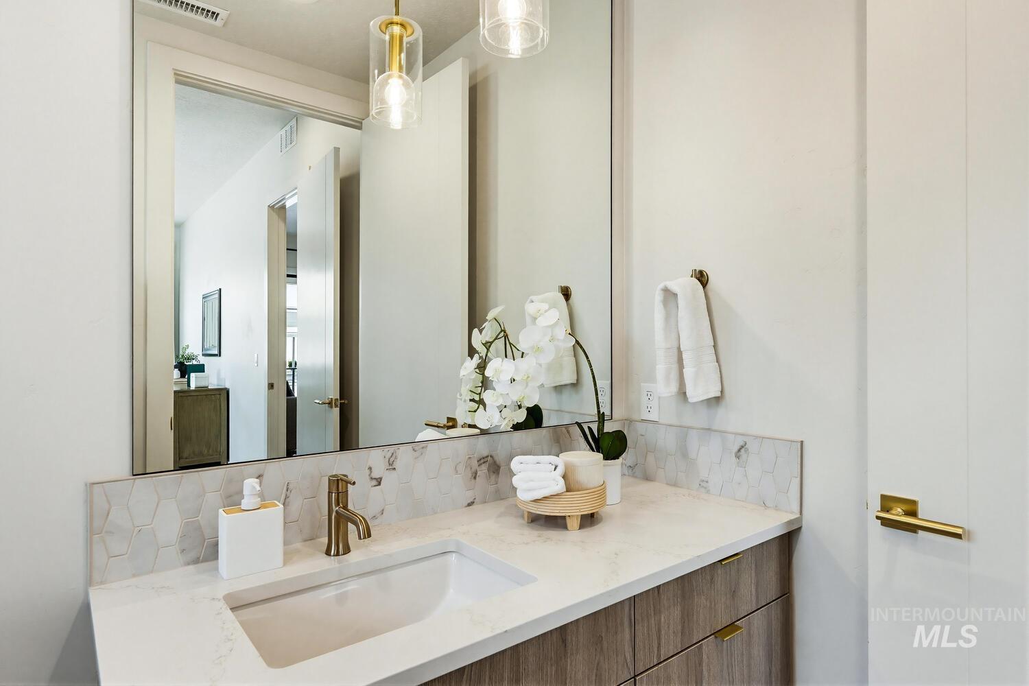 4250 Haystack, Unit 104 Boise, ID 83716 - Photo 18 of 49 Bathroom with backsplash and vanity