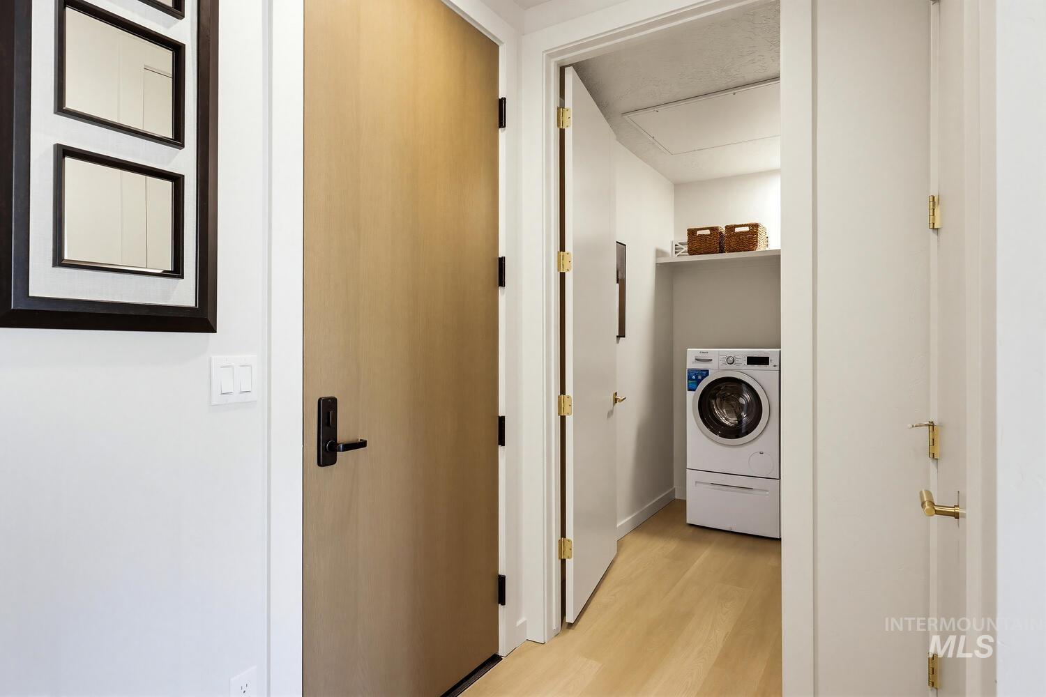 4250 Haystack, Unit 104 Boise, ID 83716 - Photo 27 of 49 Laundry area featuring washer / clothes dryer and light wood-style floors