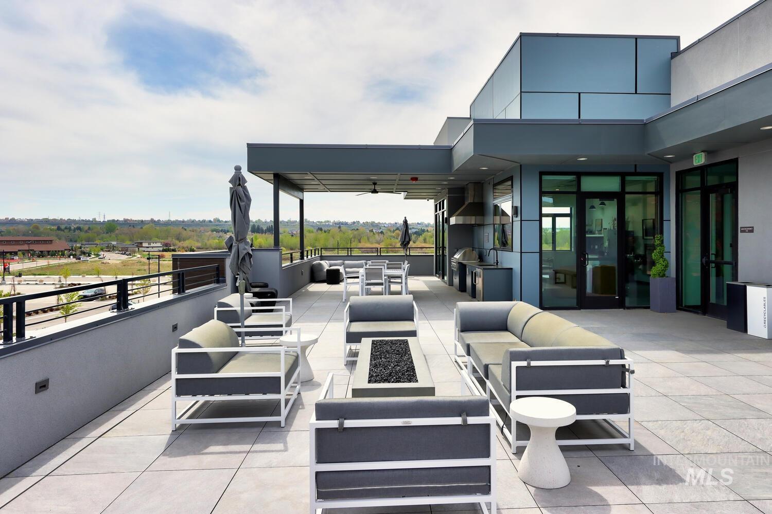 4250 Haystack, Unit 104 Boise, ID 83716 - Photo 37 of 49 View of patio with ceiling fan, an outdoor kitchen and area to lounge, and a fire pit