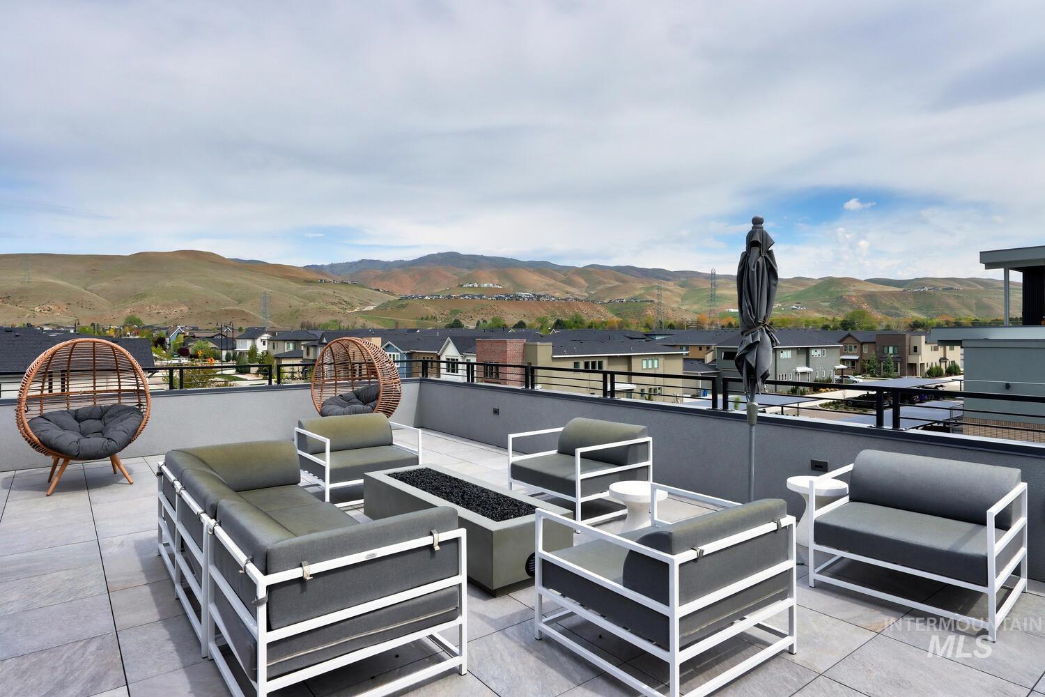 4250 Haystack, Unit 104 Boise, ID 83716 - Photo 38 of 49 View of patio / terrace featuring an outdoor living space with a fire pit, a mountain view, and a residential view