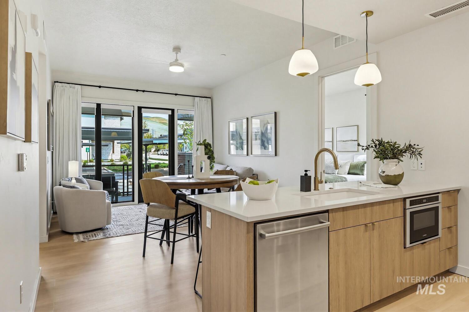 4250 Haystack, Unit 104 Boise, ID 83716 - Photo 48 of 49 Kitchen featuring a peninsula, open floor plan, stainless steel appliances, and light wood-style floors