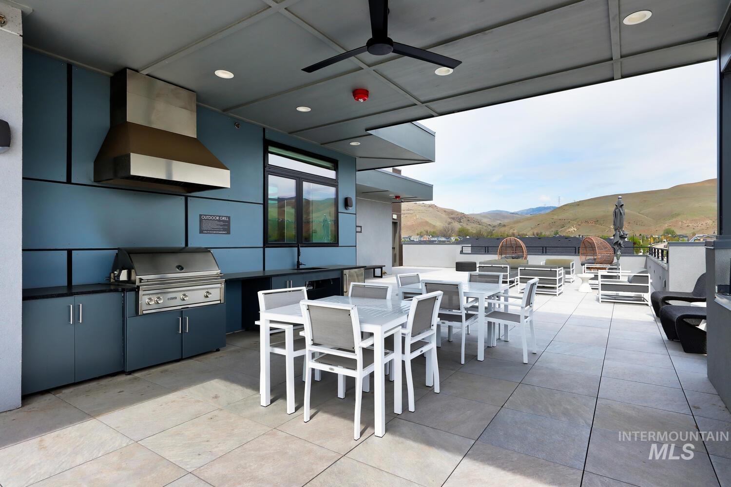 4250 Haystack, Unit 104 Boise, ID 83716 - Photo 40 of 49 View of patio / terrace featuring a mountain view, an outdoor kitchen / dining area, and a ceiling fan
