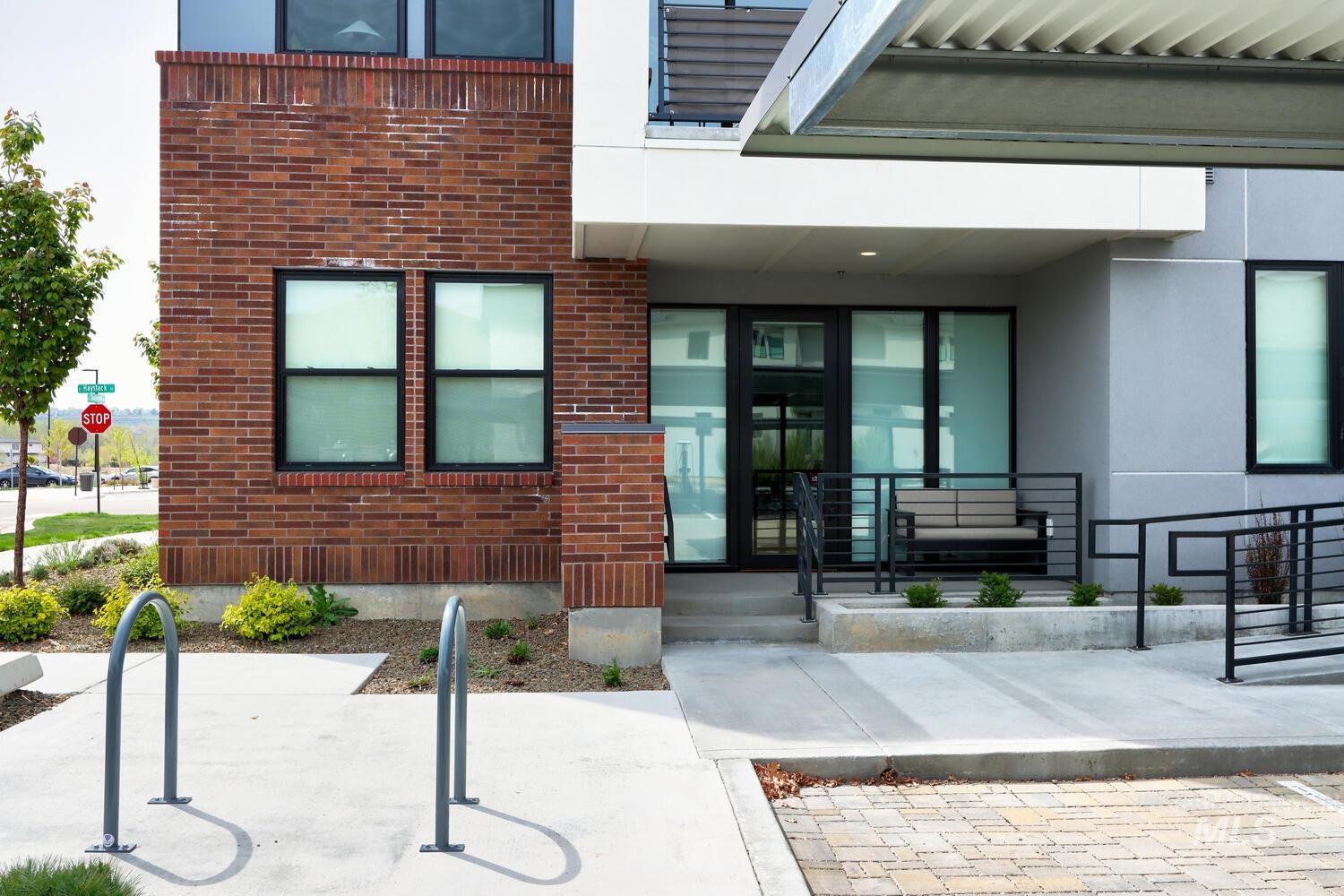 4250 Haystack, Unit 104 Boise, ID 83716 - Photo 41 of 49 Entrance to property with brick siding, a porch, and stucco siding