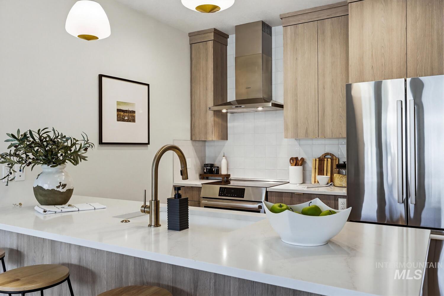 4250 Haystack, Unit 104 Boise, ID 83716 - Photo 6 of 49 Kitchen with modern cabinets, light stone countertops, stainless steel appliances, and tasteful backsplash