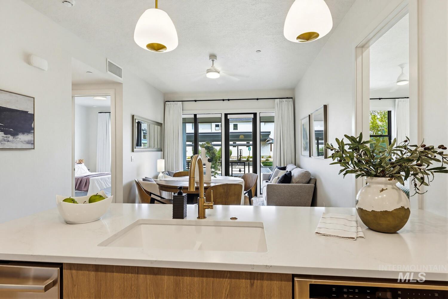 4250 Haystack, Unit 104 Boise, ID 83716 - Photo 49 of 49 Kitchen with open floor plan, light stone counters, dishwasher, and ceiling fan