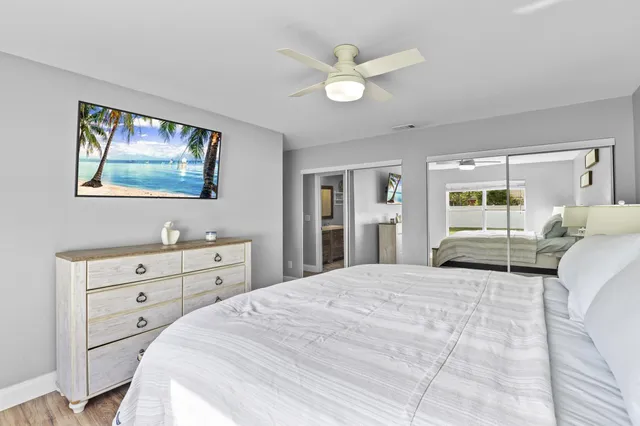 a bedroom with a large bed and a chandelier