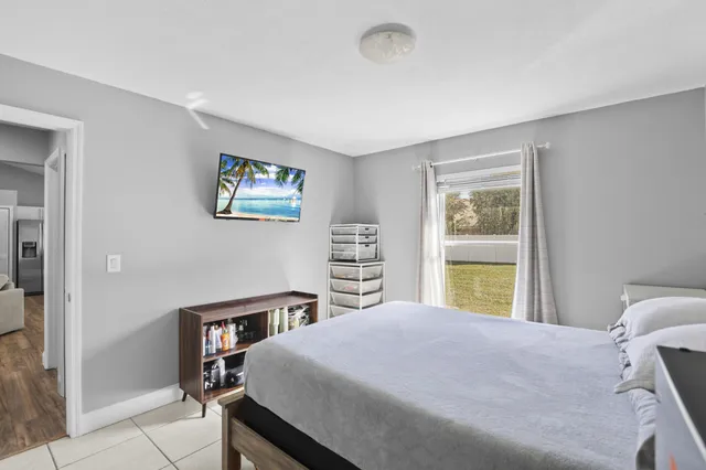 a bedroom with a large bed and a window