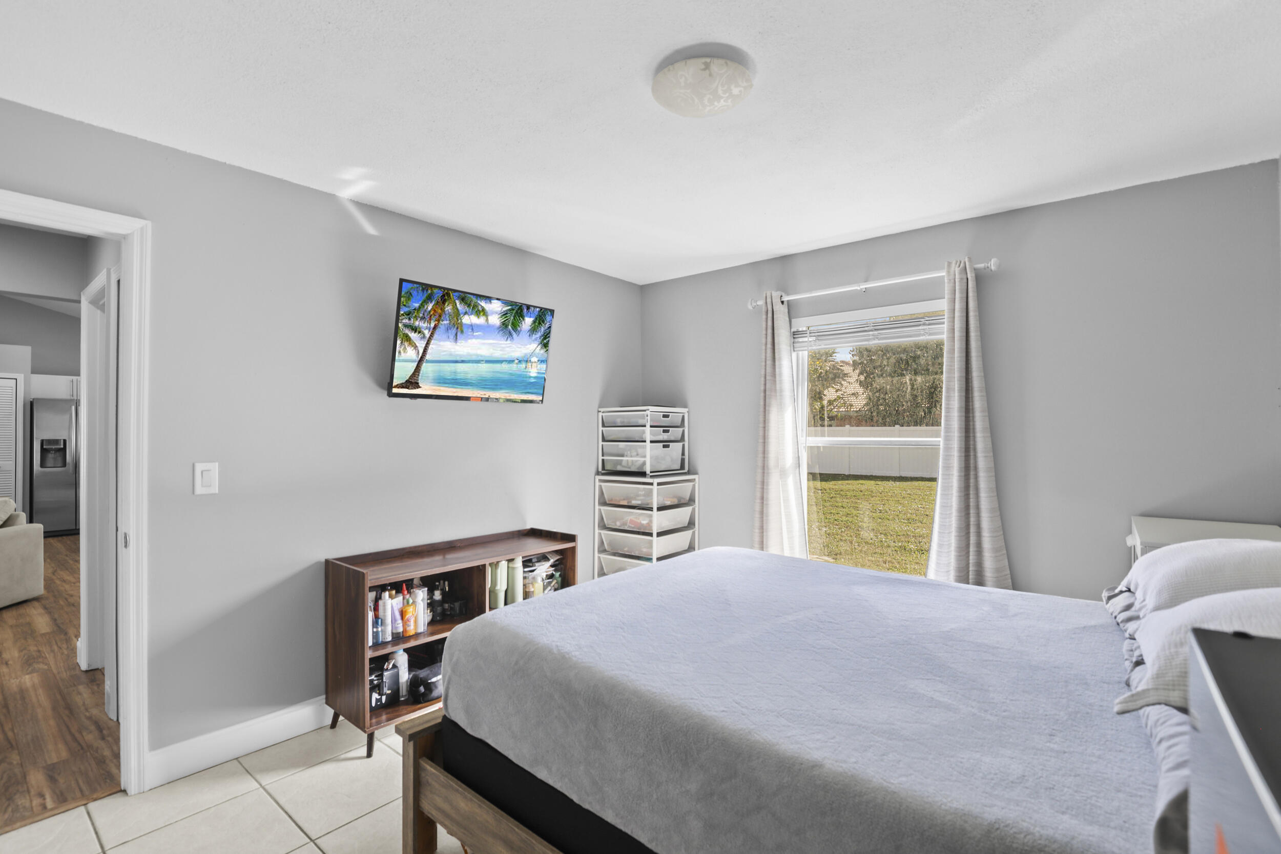 1542 Southwest Dycus Avenue Port St. Lucie, FL 34953 - Photo 20 of 34 a bedroom with a large bed and a window