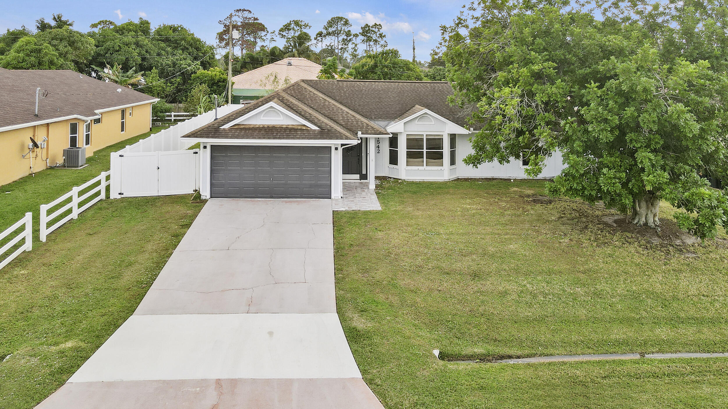 1542 Southwest Dycus Avenue Port St. Lucie, FL 34953 - Photo 2 of 34 a view of house with garden