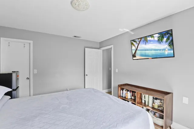 a bedroom with a bed and a book shelf