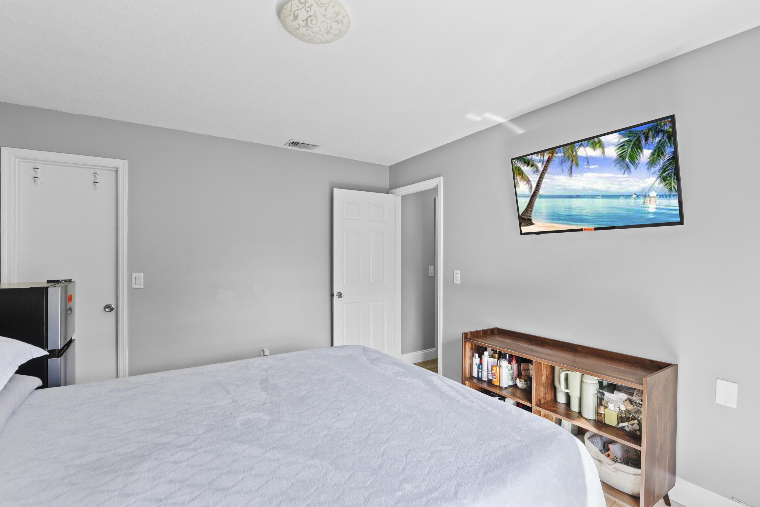 1542 Southwest Dycus Avenue Port St. Lucie, FL 34953 - Photo 21 of 34 a bedroom with a bed and a book shelf