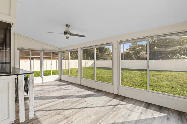 a view of an empty room with a fireplace and a large window