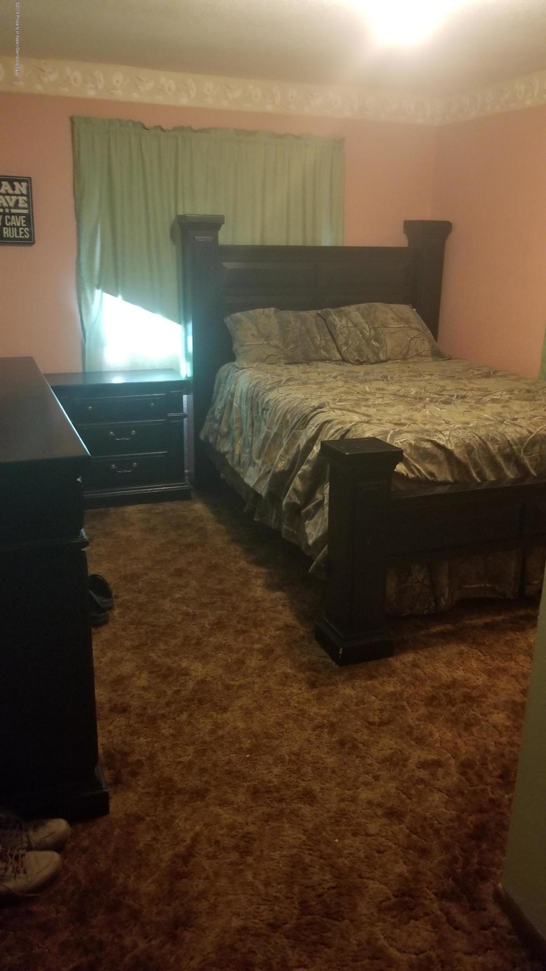 1428 Jays Avenue Rifle, CO 81650 - Photo 11 of 14 a bed sitting in a bedroom next to a window