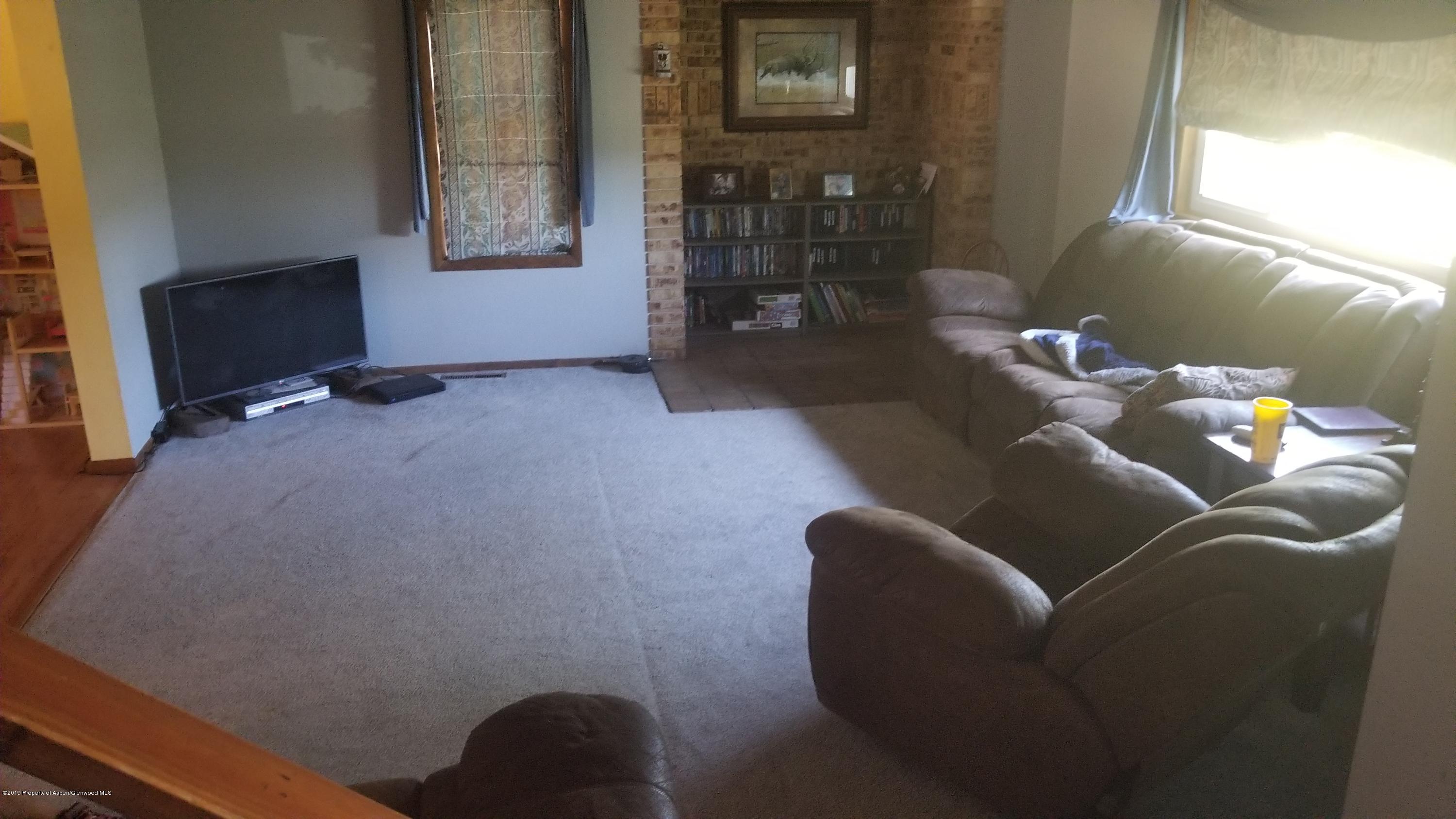 1428 Jays Avenue Rifle, CO 81650 - Photo 2 of 14 a living room with furniture and a flat screen tv