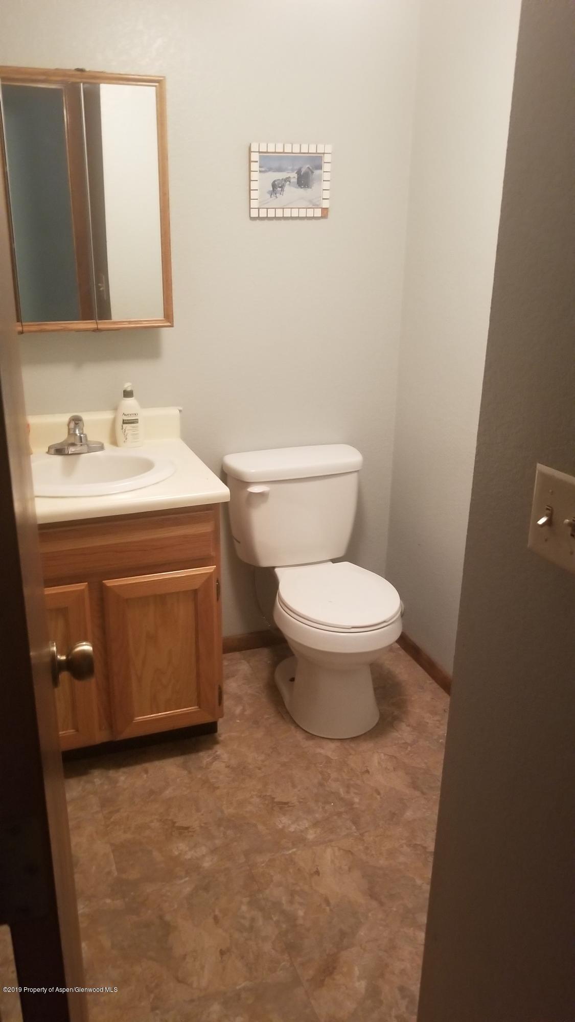 1428 Jays Avenue Rifle, CO 81650 - Photo 6 of 14 a bathroom with a sink toilet and mirror