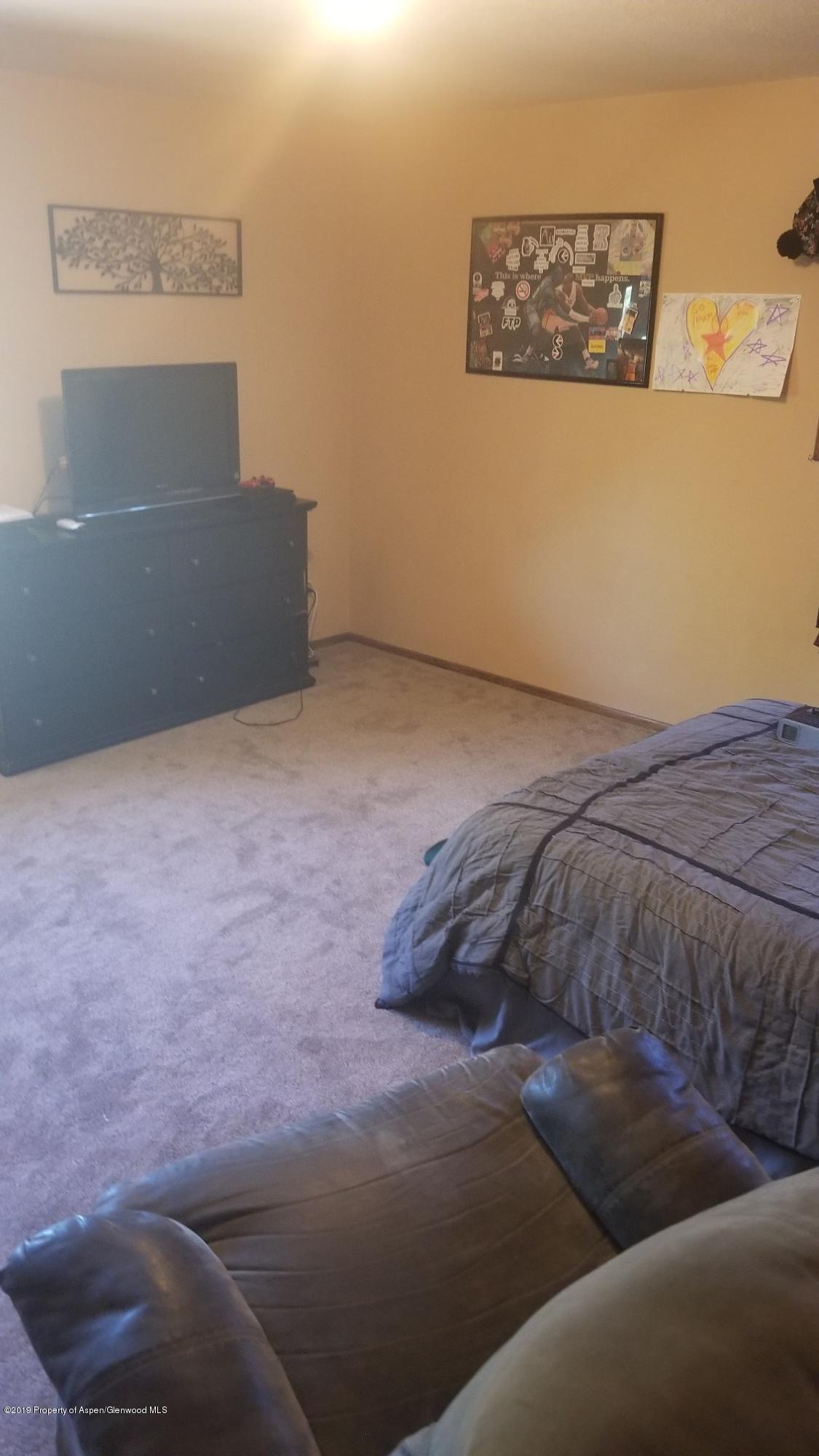 1428 Jays Avenue Rifle, CO 81650 - Photo 7 of 14 a bedroom with a bed and wall painting