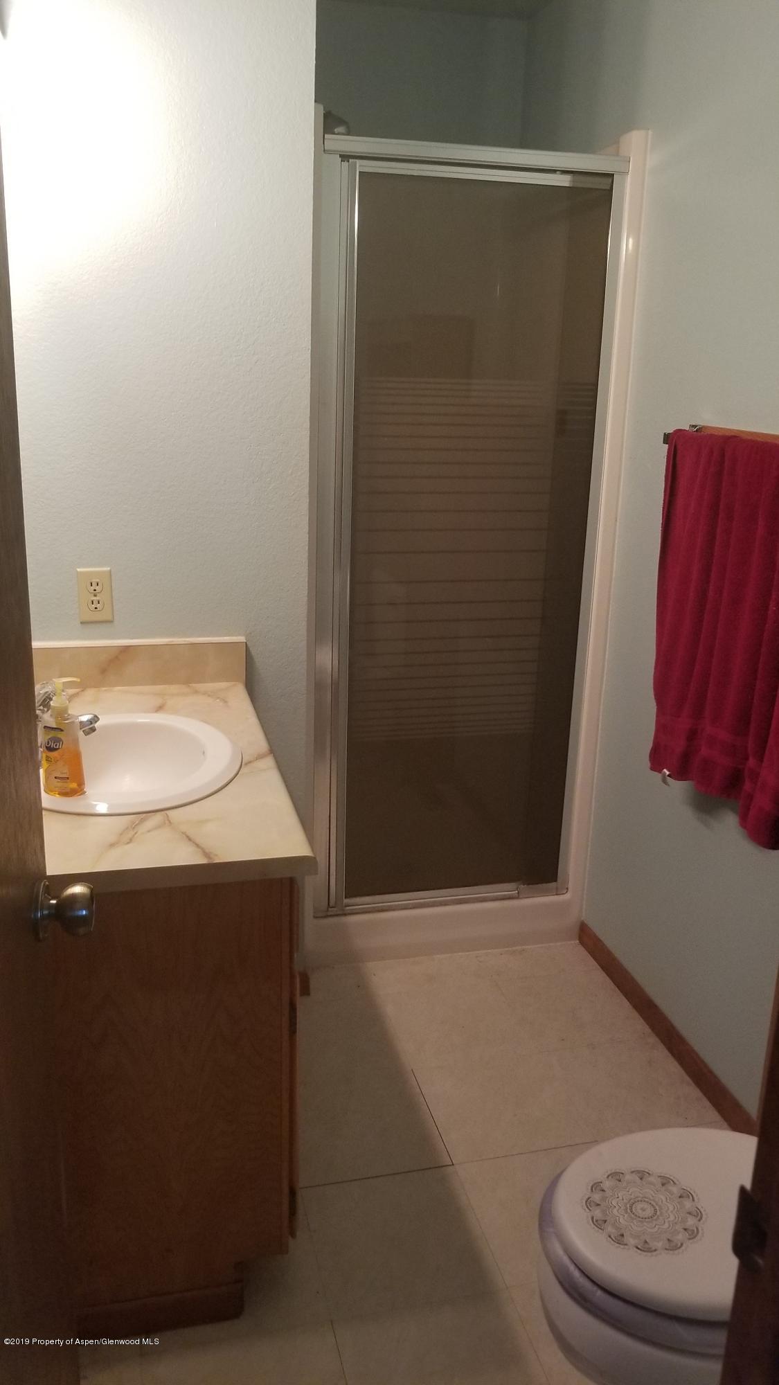1428 Jays Avenue Rifle, CO 81650 - Photo 9 of 14 a bathroom with a sink and a mirror