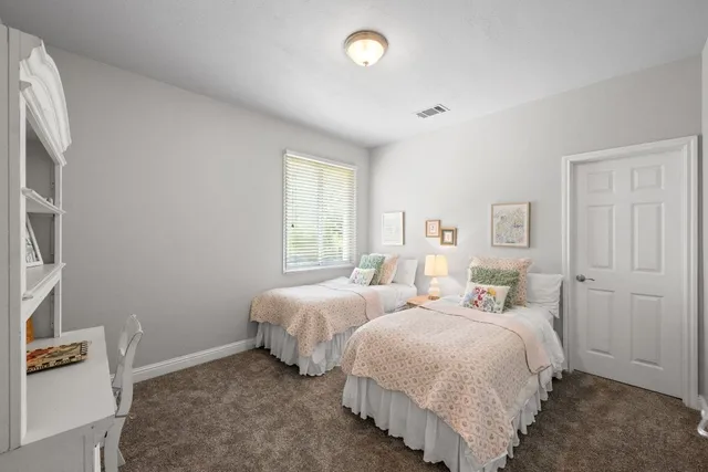 a bed room with two beds and a window