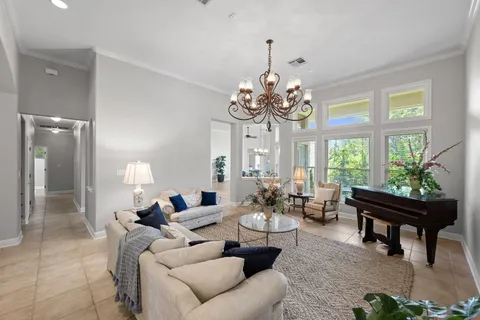 a living room with furniture and a chandelier