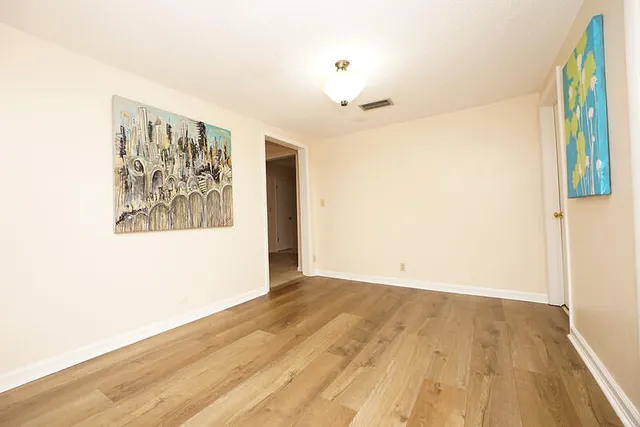 a view of hallway with wooden floor