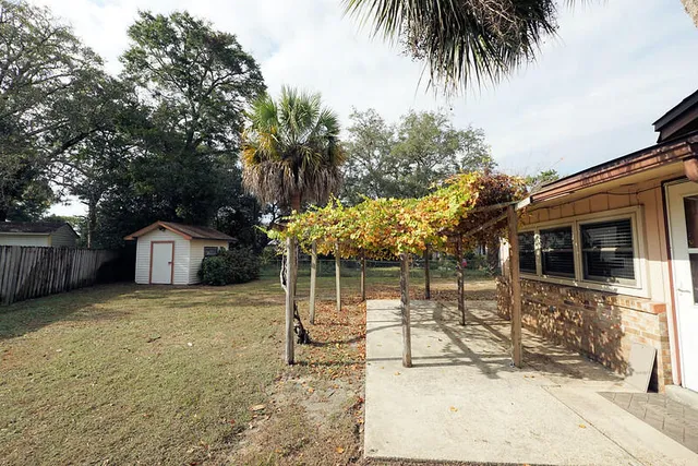 a view of a house with a yard and potted plants