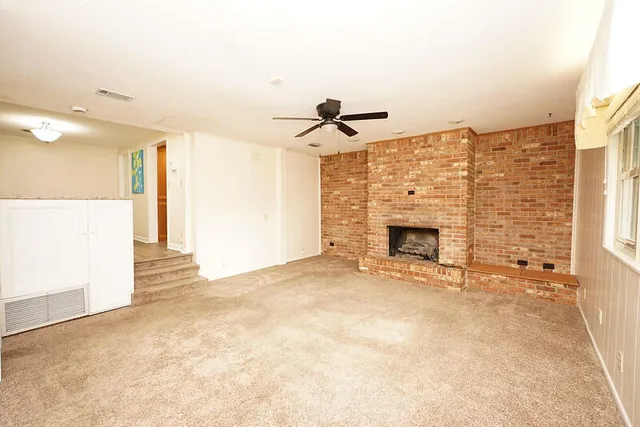 a view of a livingroom with a ceiling fan and window