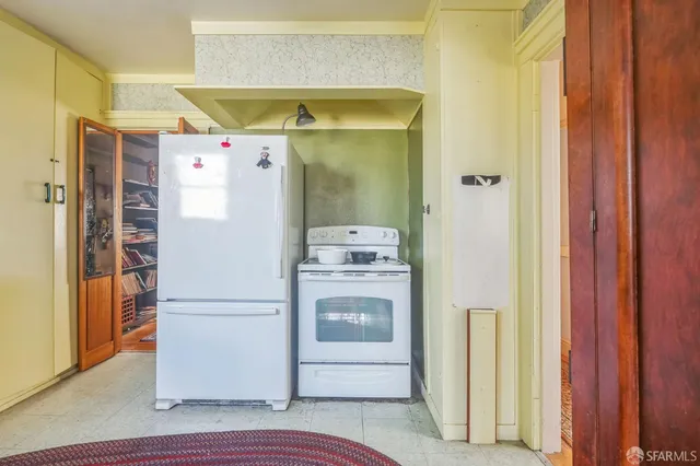 a white refrigerator freezer and a wooden floor