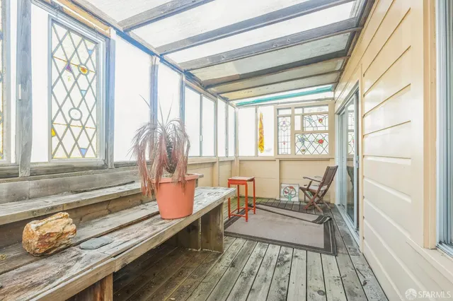 a reading room with wooden floor and furniture