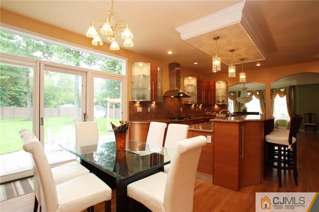17 Richard Road Edison, NJ 08820 - Photo 13 of 25 a dining room with furniture a chandelier and wooden floor