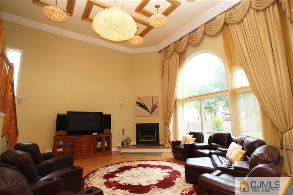 17 Richard Road Edison, NJ 08820 - Photo 14 of 25 a living room with furniture a flat screen tv and a fireplace