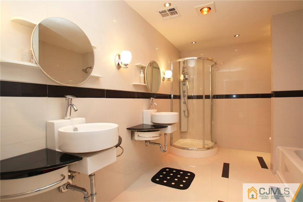 17 Richard Road Edison, NJ 08820 - Photo 18 of 25 a bathroom with a sink a mirror and a shower
