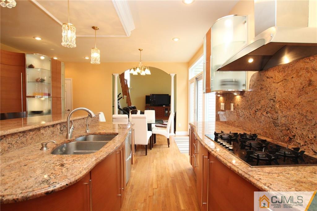 17 Richard Road Edison, NJ 08820 - Photo 10 of 25 a kitchen with stainless steel appliances granite countertop a sink a stove and a wooden floors