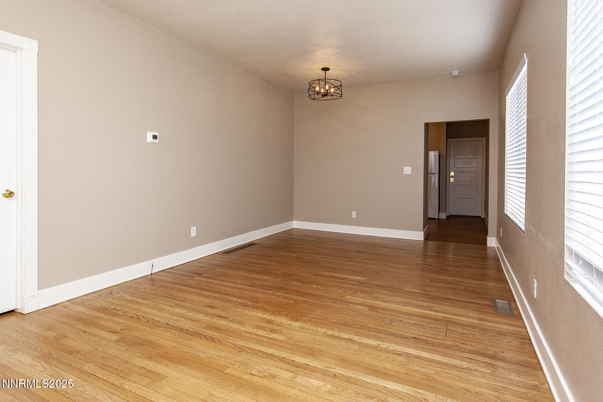 376 Wheeler Avenue Reno, NV 89502 - Photo 19 of 33 a view of an empty room with wooden floor and a window