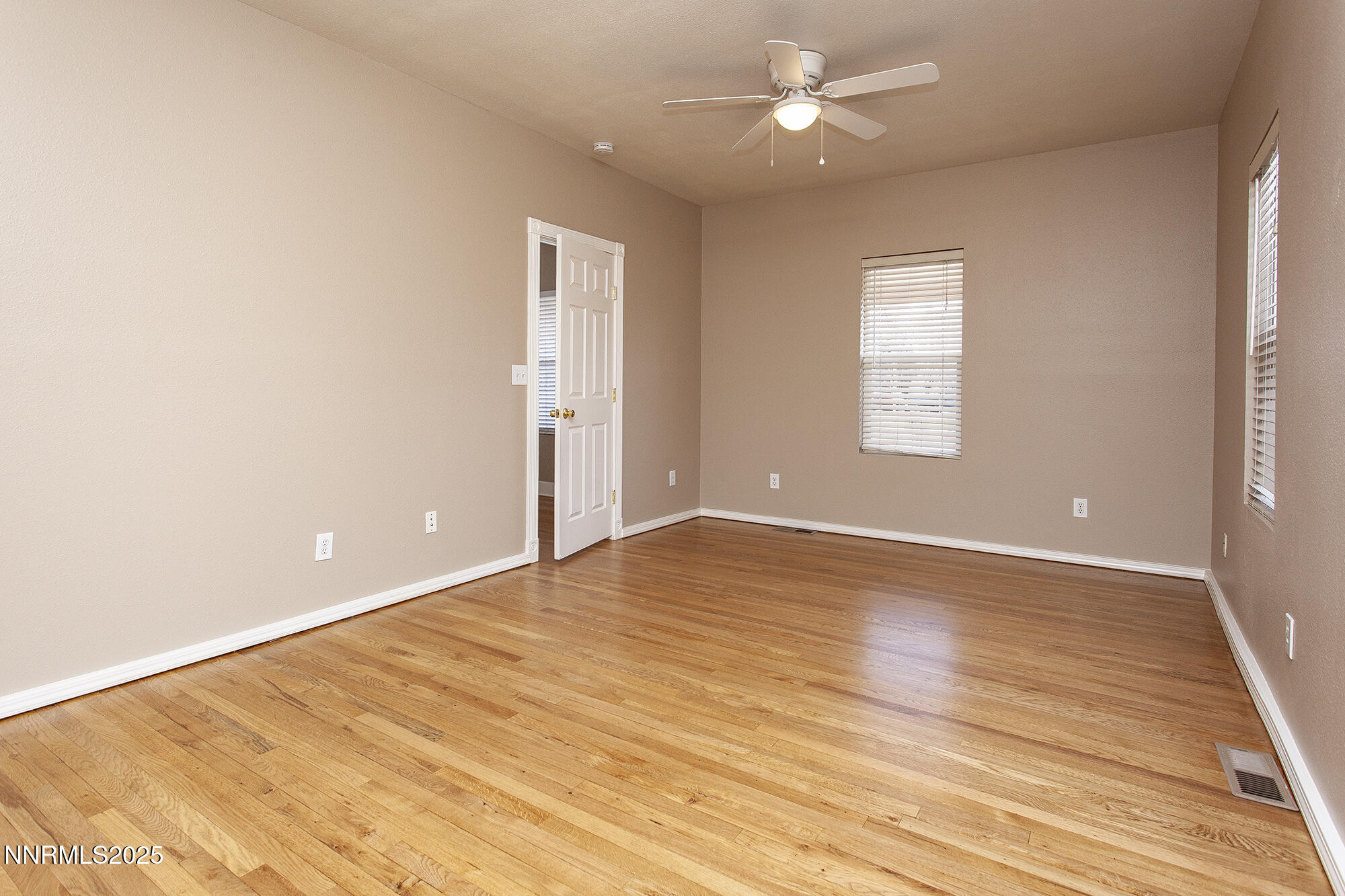 376 Wheeler Avenue Reno, NV 89502 - Photo 27 of 33 an empty room with wooden floor and windows