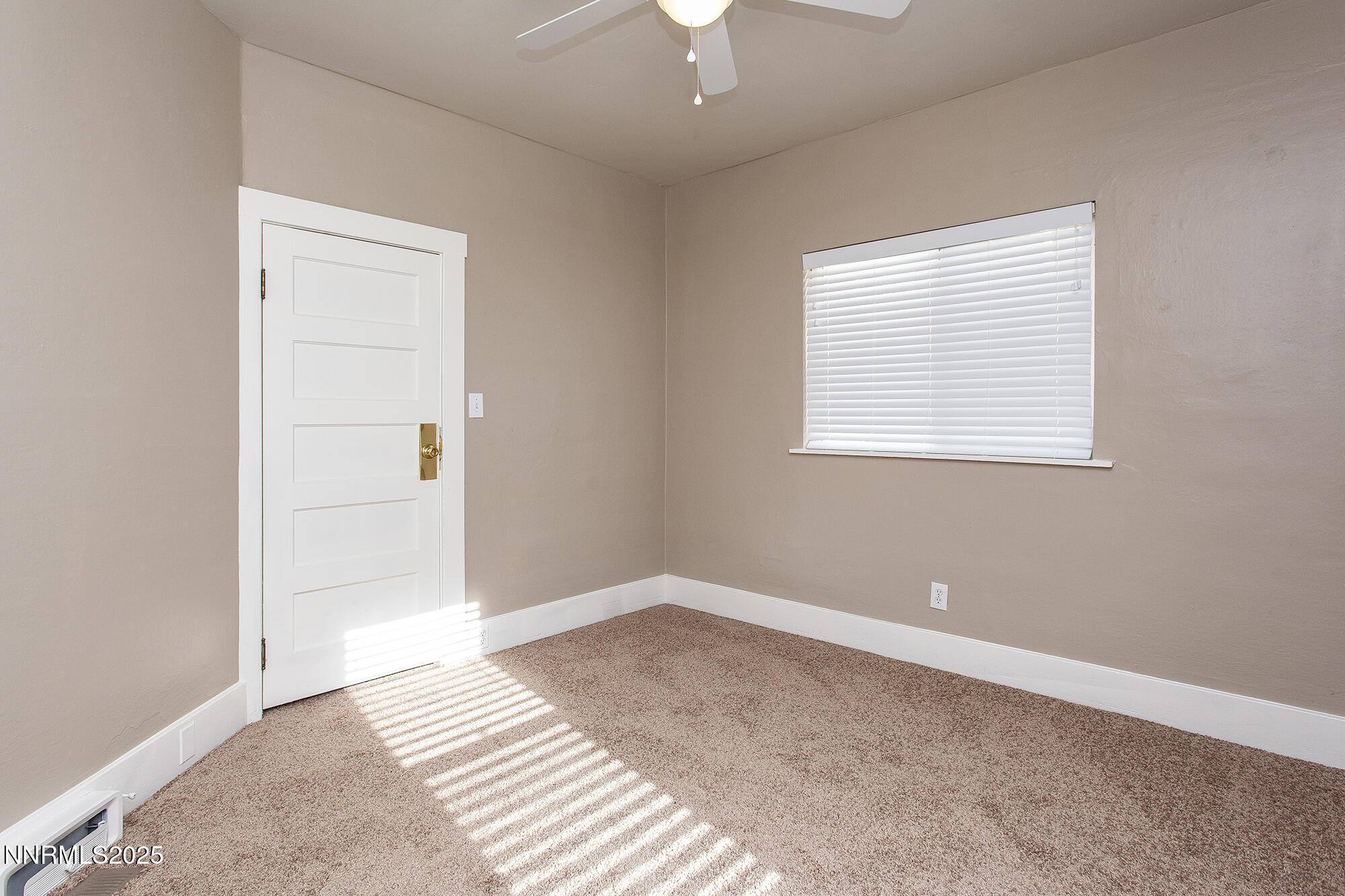 376 Wheeler Avenue Reno, NV 89502 - Photo 28 of 33 an empty room with a window and a chandelier fan