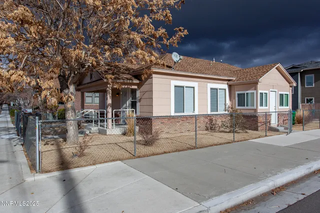 front view of a house with a tree