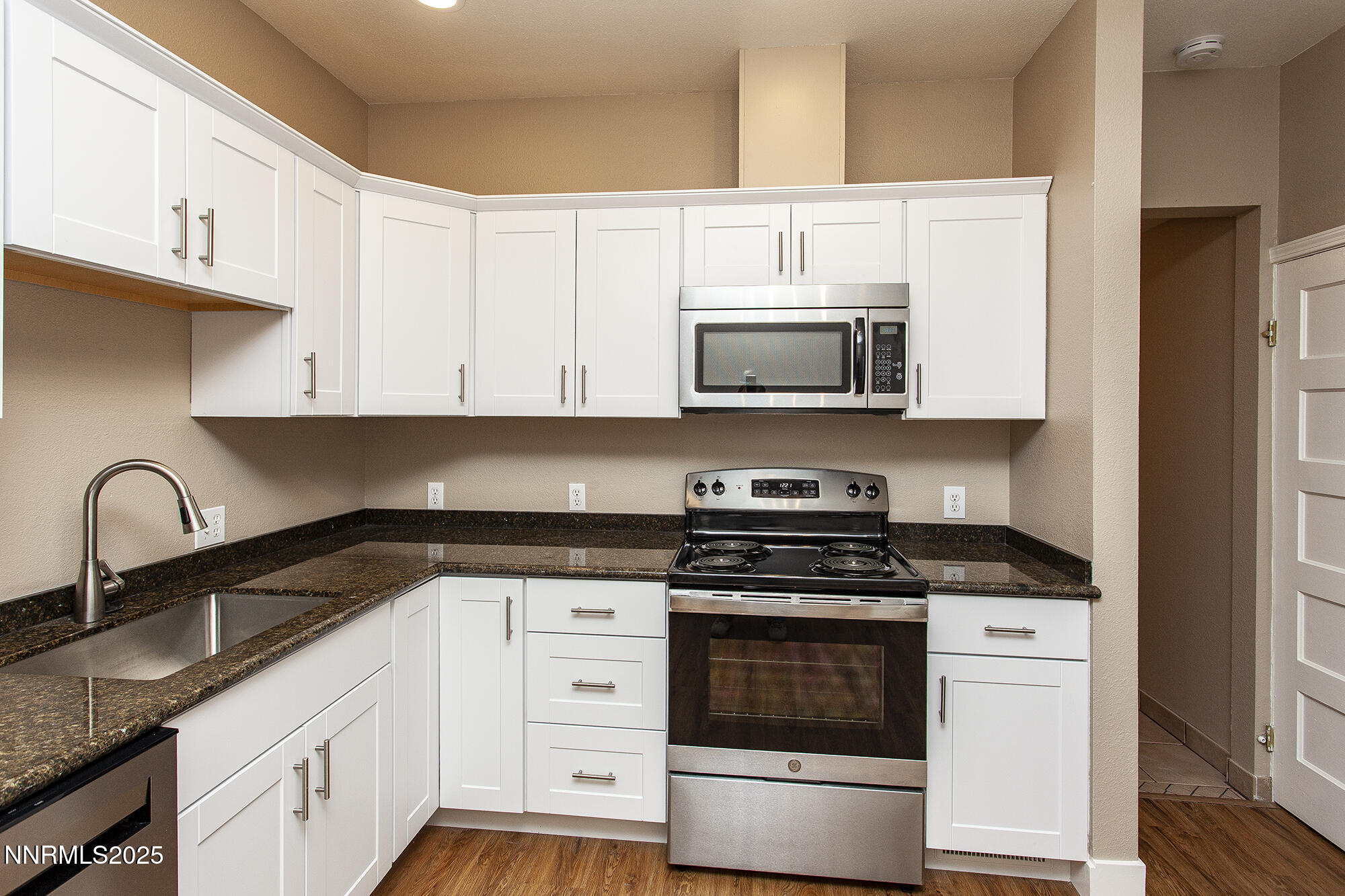 376 Wheeler Avenue Reno, NV 89502 - Photo 8 of 33 a white kitchen with granite countertop a stove and a sink