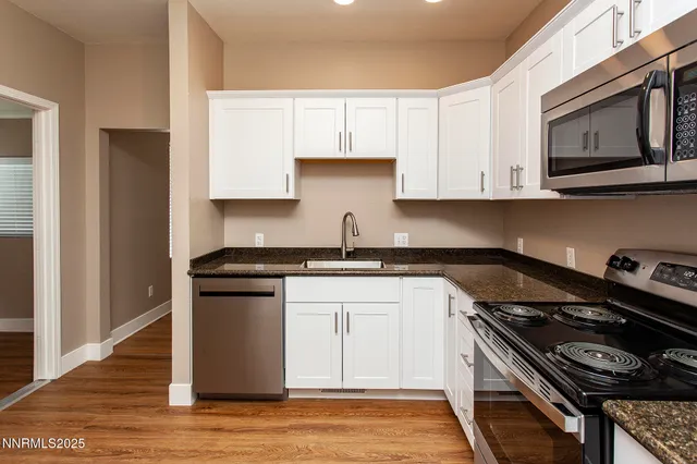 a kitchen with stainless steel appliances granite countertop a stove and a microwave