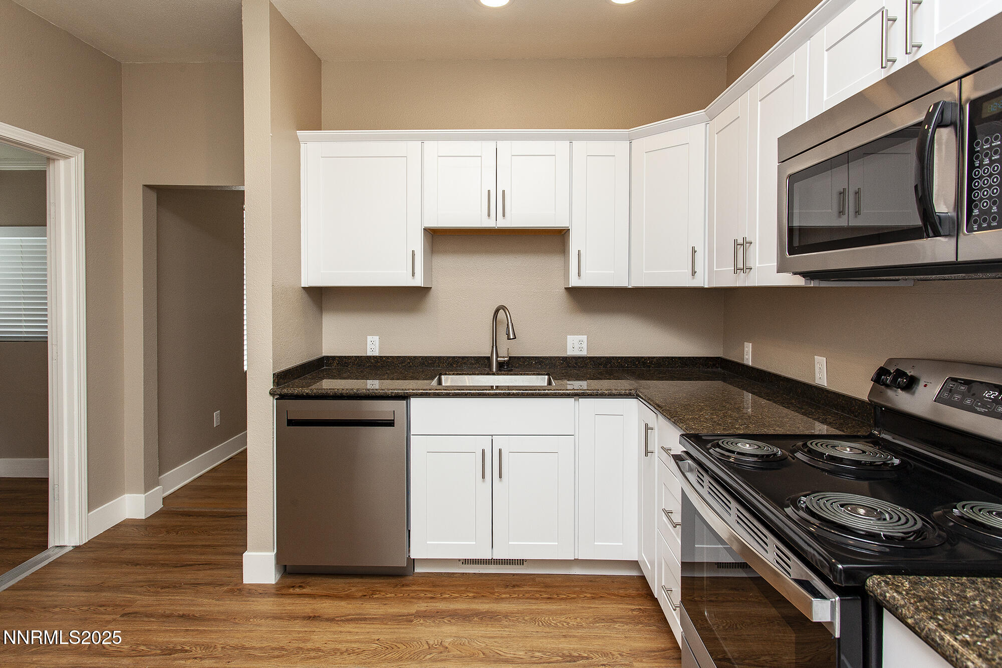 376 Wheeler Avenue Reno, NV 89502 - Photo 10 of 33 a kitchen with stainless steel appliances granite countertop a stove and a microwave