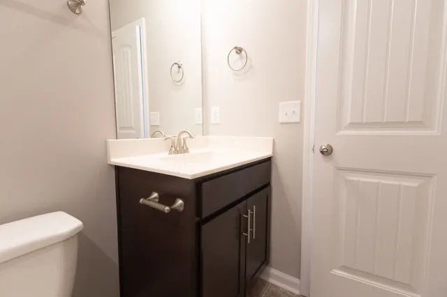 a bathroom with a sink vanity and a mirror