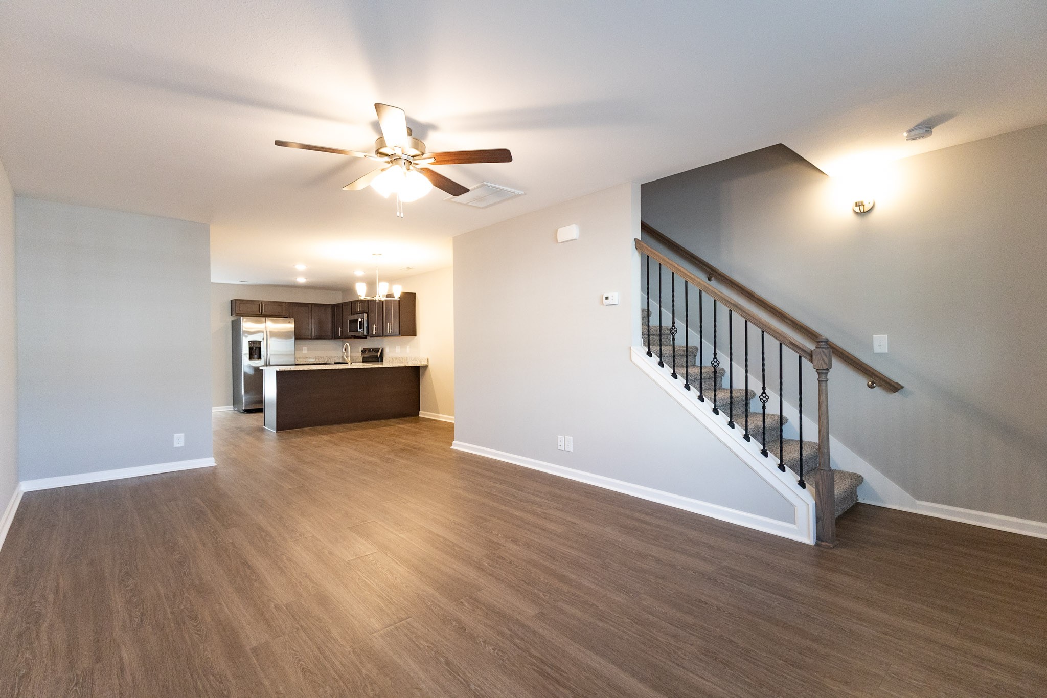 118 Davis Ridge Lane Clarksville, TN 37040 - Photo 8 of 35 a view of a livingroom with wooden floor a ceiling fan and staircase