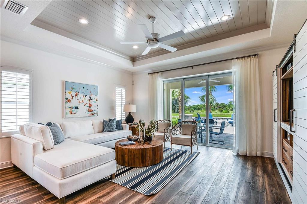 4551 Centaurus Circle Naples, FL 34120 - Photo 12 of 26 a living room with furniture fireplace and a large window