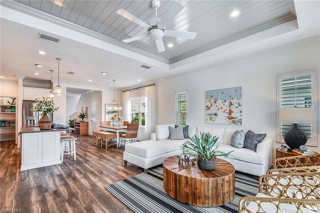 4551 Centaurus Circle Naples, FL 34120 - Photo 13 of 26 a living room with furniture and a chandelier