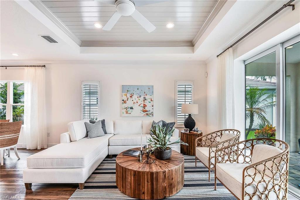 4551 Centaurus Circle Naples, FL 34120 - Photo 14 of 26 a living room with furniture and a large window