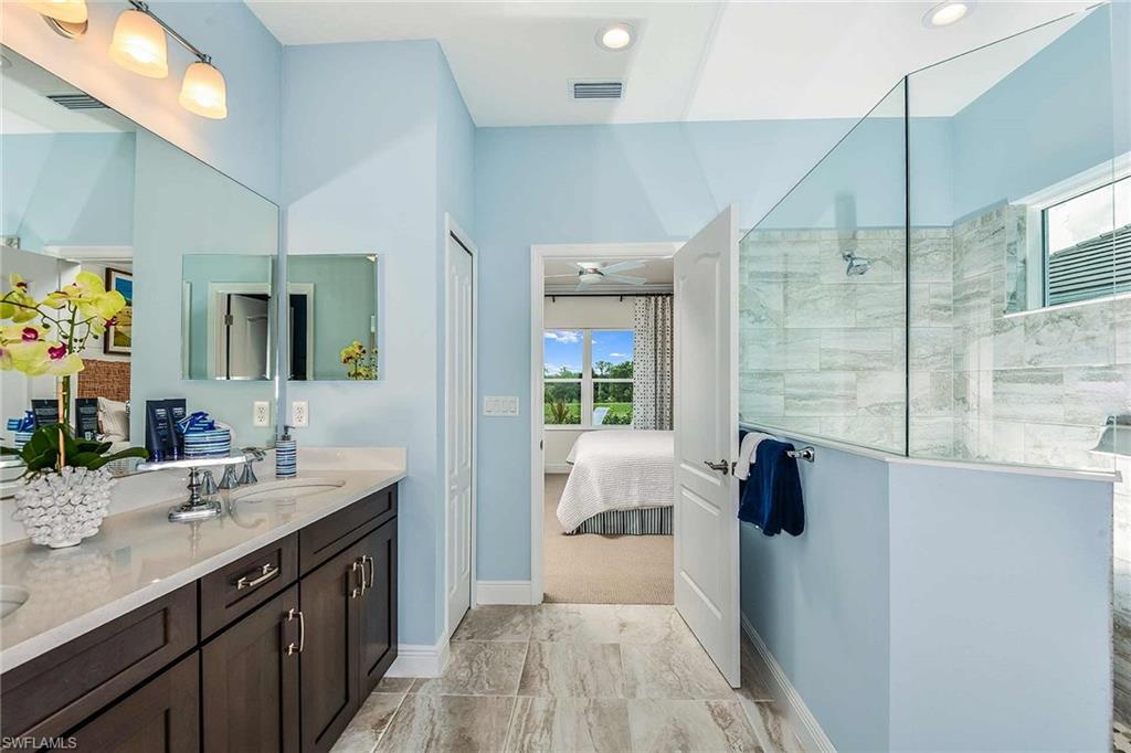 4551 Centaurus Circle Naples, FL 34120 - Photo 17 of 26 a spacious bathroom with a tub sink and mirror