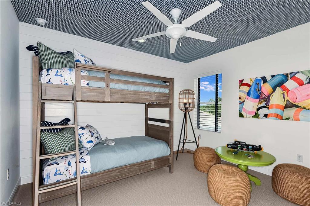 4551 Centaurus Circle Naples, FL 34120 - Photo 20 of 26 a bedroom with bed and a chandelier