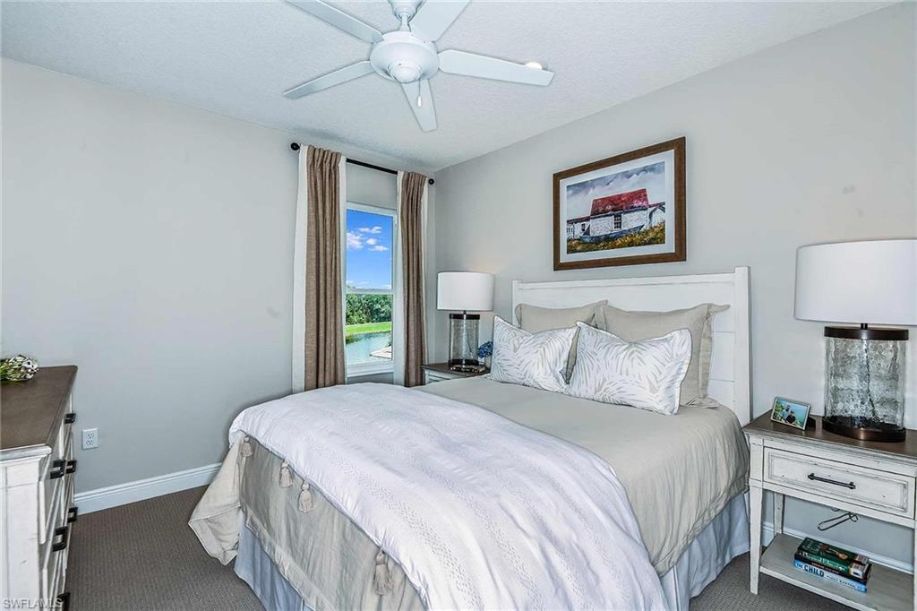 4551 Centaurus Circle Naples, FL 34120 - Photo 21 of 26 a bedroom with a bed and a chandelier