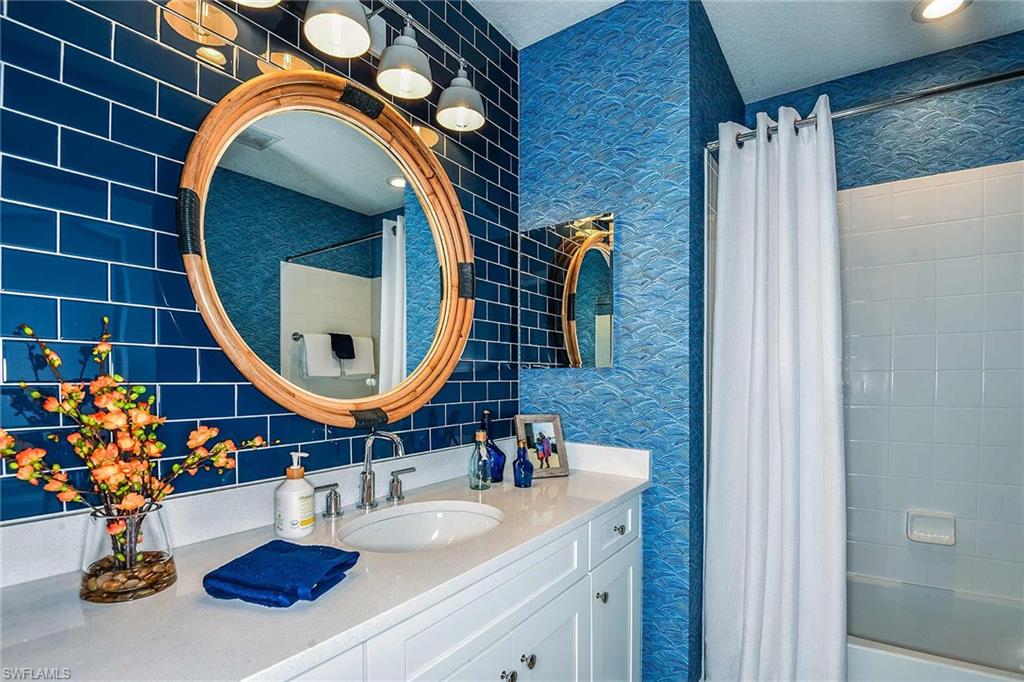 4551 Centaurus Circle Naples, FL 34120 - Photo 22 of 26 a bathroom with a sink and a mirror