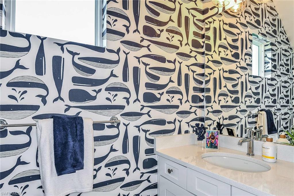 4551 Centaurus Circle Naples, FL 34120 - Photo 3 of 26 a bathroom with a sink and mirror with bathtub